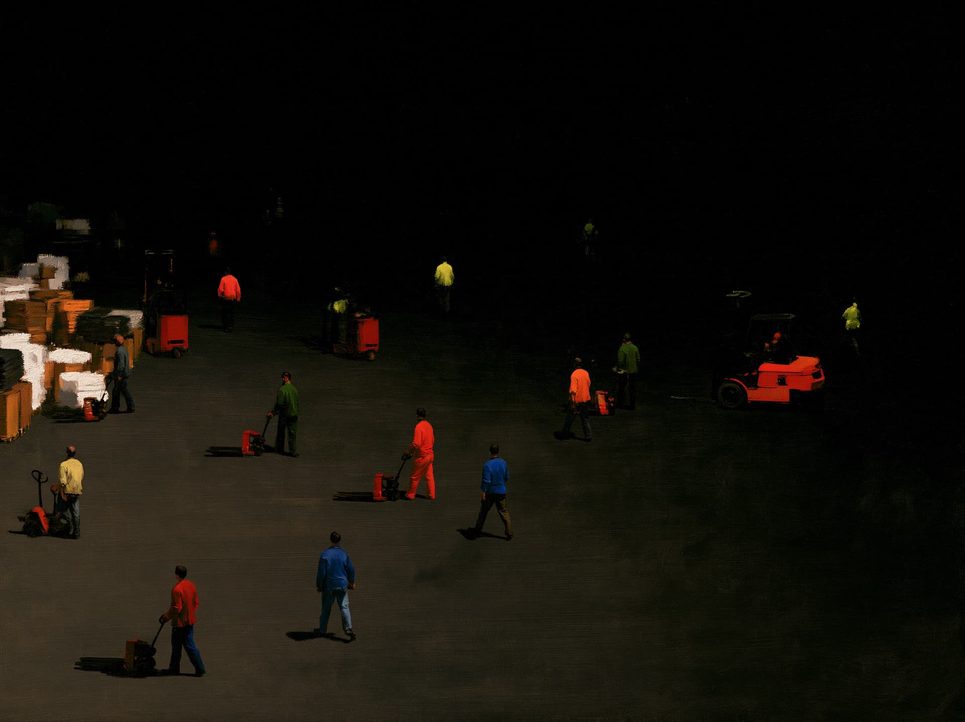 Warehouse operators moving pallet jacks across a dark distribution floor.